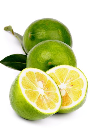 simsearch:400-08012355,k - Arrangement of Fresh Ripe Green Lemons Full Body and Halves with Leafs isolated on white background Photographie de stock - Aubaine LD & Abonnement, Code: 400-07124310