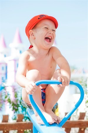 Happy child swinging on a swing Stock Photo - Budget Royalty-Free & Subscription, Code: 400-07124740