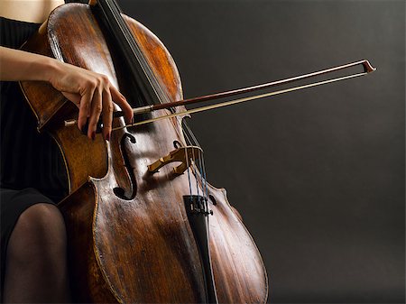 Photo of an unrecognizable female musician playing a cello. Stockbilder - Microstock & Abonnement, Bildnummer: 400-07125712