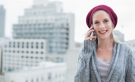 Cheerful pretty blonde on the phone outdoors on urban background Stock Photo - Budget Royalty-Free & Subscription, Code: 400-07126126