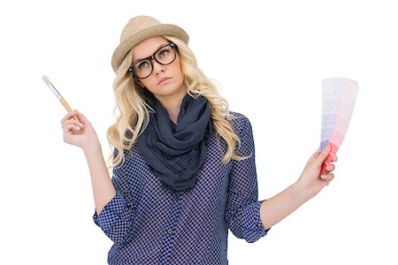 simsearch:400-06956665,k - Pensive trendy blonde with classy glasses holding color chart on white background Stockbilder - Microstock & Abonnement, Bildnummer: 400-07126941