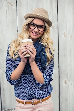 simsearch:400-04807075,k - Happy trendy blonde holding coffee outdoors on wooden background Foto de stock - Super Valor sin royalties y Suscripción, Código: 400-07126955