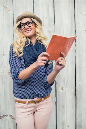 simsearch:400-07059876,k - Cheerful fashionable blonde holding book outdoors on wooden background Foto de stock - Super Valor sin royalties y Suscripción, Código: 400-07126950