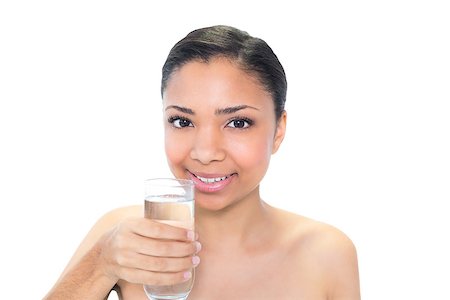 Cheerful young dark haired model holding a glass of water on white background Photographie de stock - Aubaine LD & Abonnement, Code: 400-07127089