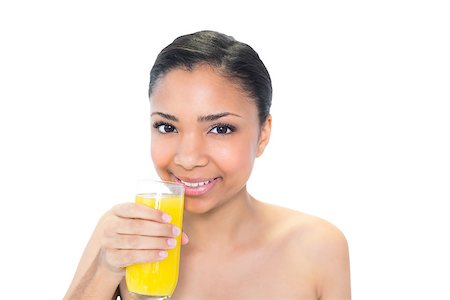 Happy young dark haired model drinking orange juice on white background Photographie de stock - Aubaine LD & Abonnement, Code: 400-07127092