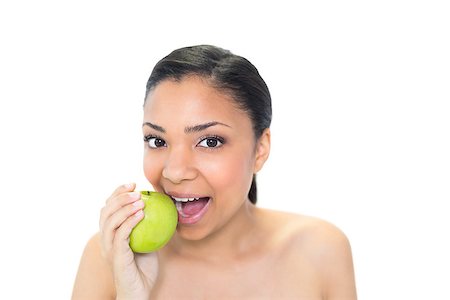 Playful young dark haired model eating a green apple on white background Photographie de stock - Aubaine LD & Abonnement, Code: 400-07127102