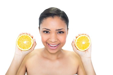 Joyful young dark haired model holding orange halves on white background Foto de stock - Super Valor sin royalties y Suscripción, Código: 400-07127110