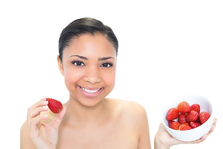 Content young dark haired model eating strawberries on white background Photographie de stock - Aubaine LD & Abonnement, Code: 400-07127113
