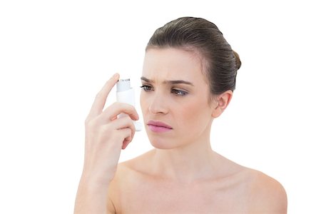 photo inhaler person - Puzzled natural brown haired model looking at an asthma inhaler on white background Stock Photo - Budget Royalty-Free & Subscription, Code: 400-07127584