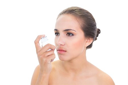 photo inhaler person - Upset young brunette woman holding an inhaler on white background Stock Photo - Budget Royalty-Free & Subscription, Code: 400-07128026