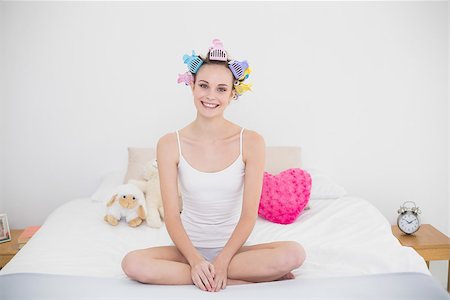 Smiling natural brown haired woman in hair curlers practicing yoga in bright bedroom Stock Photo - Budget Royalty-Free & Subscription, Code: 400-07129679