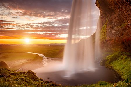 seljalandsfoss waterfall - Seljalandsfoss is one of the most beautiful waterfalls on the Iceland. It is located on the South of the island. This photo is taken during the incredible sunset at approx. 1 AM. Photographie de stock - Aubaine LD & Abonnement, Code: 400-07122920