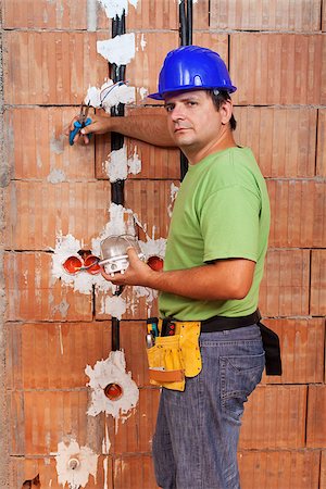 simsearch:693-06324870,k - Electrician working inside new building installing wires Stock Photo - Budget Royalty-Free & Subscription, Code: 400-07122945