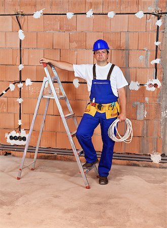 Electrician working in a new building - installing wires and making connections Stock Photo - Budget Royalty-Free & Subscription, Code: 400-07123029