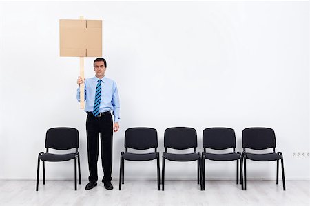 proteger - Businessman protesting alone with a placard - fighting for lost causes concept Stock Photo - Budget Royalty-Free & Subscription, Code: 400-07123035