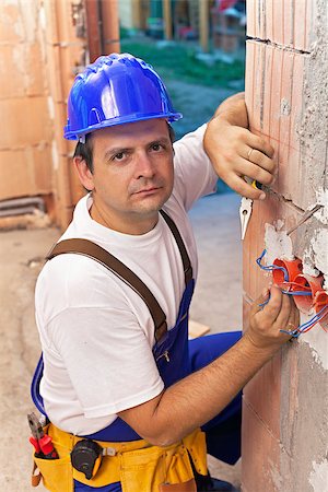 Electrician installing wires in a new brick building Stock Photo - Budget Royalty-Free & Subscription, Code: 400-07123030