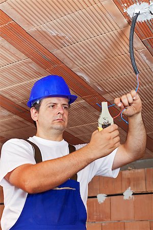 simsearch:693-06324870,k - Electrician working with the ceiling wiring in a new building Stock Photo - Budget Royalty-Free & Subscription, Code: 400-07123046