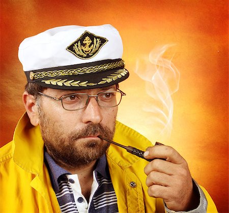 sailor captains uniform - Portrait of a sea â??â??wolf smoking a pipe Stock Photo - Budget Royalty-Free & Subscription, Code: 400-07123124