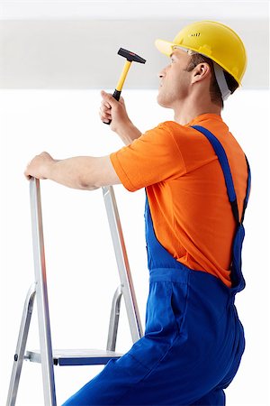 simsearch:400-07165423,k - Builder on a ladder with hammer Foto de stock - Royalty-Free Super Valor e Assinatura, Número: 400-07123328