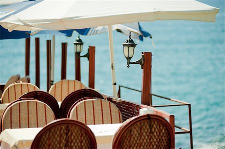 dinner on the beach - Table in a restaurant by the sea. Photographie de stock - Aubaine LD & Abonnement, Code: 400-07123395