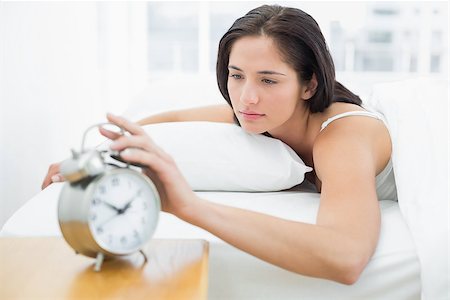 simsearch:614-02613098,k - Young woman in bed extending hand to alarm clock at home Stockbilder - Microstock & Abonnement, Bildnummer: 400-07134035