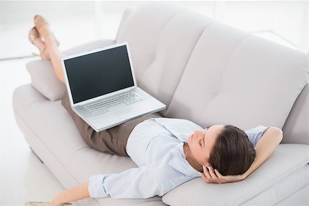 simsearch:400-07274613,k - High angle view of a young woman with laptop lying on sofa at home Stock Photo - Budget Royalty-Free & Subscription, Code: 400-07135174