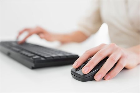 Close up midsection of businesswoman using keyboard and mouse in office Stock Photo - Budget Royalty-Free & Subscription, Code: 400-07135449