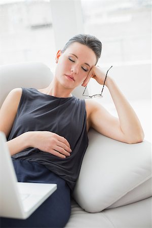 simsearch:400-07274613,k - Beautiful well dressed young woman resting on sofa while using laptop at home Stock Photo - Budget Royalty-Free & Subscription, Code: 400-07135529