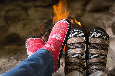 Close up of romantic couple's legs in socks in front of fireplace at winter season at home Photographie de stock - Aubaine LD & Abonnement, Code: 400-07135854