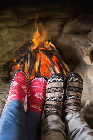 Close up of romantic couple's legs in socks in front of fireplace at winter season at home Photographie de stock - Aubaine LD & Abonnement, Code: 400-07135855