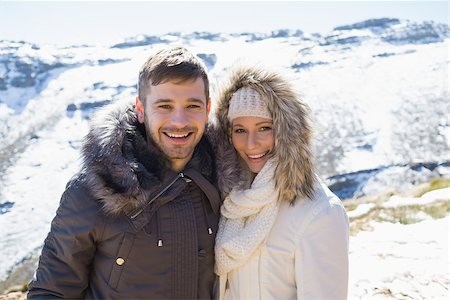 snowed - Portrait of a smiling young couple in fur hood jackets against snowed mountain range Stock Photo - Budget Royalty-Free & Subscription, Code: 400-07136077