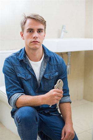 plumber (male) - Portrait of a serious male plumber with wrench against sink in bathroom Stock Photo - Budget Royalty-Free & Subscription, Code: 400-07137003