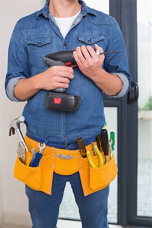 Close up mid section of a handyman with drill and toolbelt Stock Photo - Budget Royalty-Free & Subscription, Code: 400-07137044