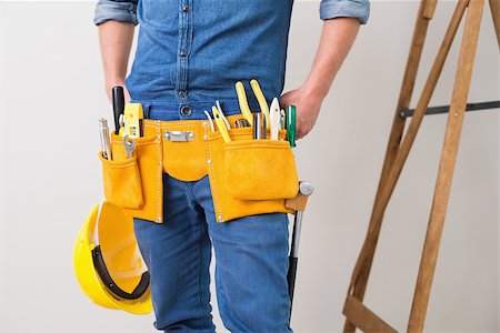 Mid section of a handyman with toolbelt around his waist and hard hat Stock Photo - Budget Royalty-Free & Subscription, Code: 400-07137073