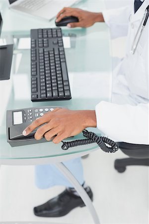 Close up low section of doctor using computer at medical office Stock Photo - Budget Royalty-Free & Subscription, Code: 400-07137529