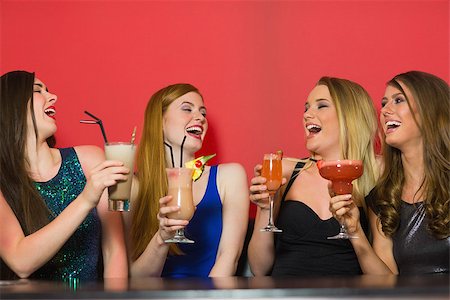 simsearch:649-06844392,k - Laughing friends holding cocktails and chatting in a nightclub Stock Photo - Budget Royalty-Free & Subscription, Code: 400-07137878