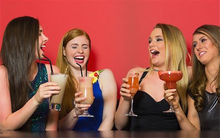 simsearch:649-06844392,k - Chatting friends holding cocktails and laughing in a nightclub Stock Photo - Budget Royalty-Free & Subscription, Code: 400-07137879