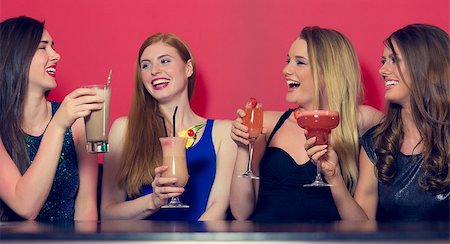 simsearch:649-06844392,k - Attractive friends clubbing holding cocktails and chatting in a nightclub Stock Photo - Budget Royalty-Free & Subscription, Code: 400-07137880