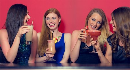 simsearch:649-06844392,k - Four friends having a party holding cocktails and chatting in a nightclub Stock Photo - Budget Royalty-Free & Subscription, Code: 400-07137881