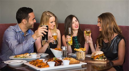 pic of friends in bar celebration - Happy friends sitting together having dinner in a restaurant Stock Photo - Budget Royalty-Free & Subscription, Code: 400-07137932