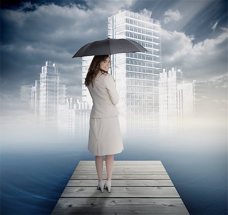 Smiling businesswoman standing on bridge in front of white city with black umbrella Stock Photo - Budget Royalty-Free & Subscription, Code: 400-07137981