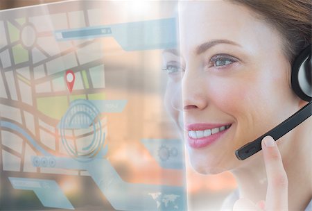 simsearch:400-07138128,k - Happy call center employee looking at futuristic interface hologram touching her headset Stock Photo - Budget Royalty-Free & Subscription, Code: 400-07138116