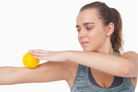 simsearch:400-07138263,k - Woman using a massage ball for her arms on white screen Stock Photo - Budget Royalty-Free & Subscription, Code: 400-07138197