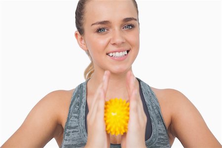 simsearch:400-07138263,k - Happy woman holding massage ball between her hands on white screen Stock Photo - Budget Royalty-Free & Subscription, Code: 400-07138199