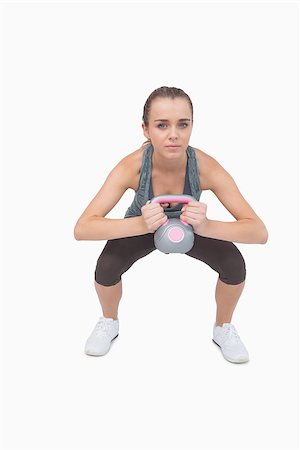 simsearch:400-07138263,k - Attractive fit woman working with a kettle bell looking at screen Stock Photo - Budget Royalty-Free & Subscription, Code: 400-07138191