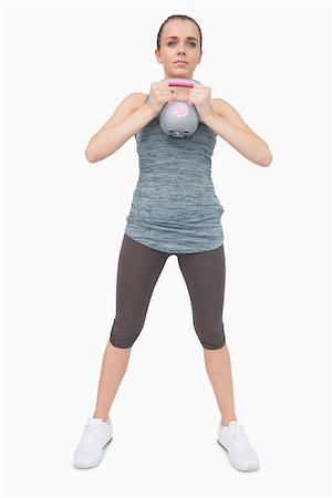 simsearch:400-07138263,k - Cute woman training her body with a kettle bell on white screen Stock Photo - Budget Royalty-Free & Subscription, Code: 400-07138193