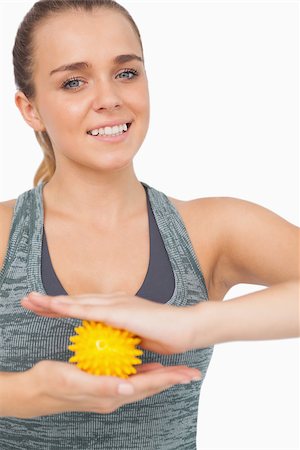 simsearch:400-07138263,k - Attractive woman holding yellow massage ball between her hands smiling at camera Stock Photo - Budget Royalty-Free & Subscription, Code: 400-07138204