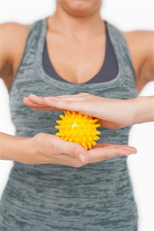 simsearch:400-07138263,k - Close up of young woman holding yellow massage ball between her hands on white screen Stock Photo - Budget Royalty-Free & Subscription, Code: 400-07138206