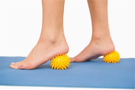 Close up of female feet touching massage ball on blue floor Stock Photo - Budget Royalty-Free & Subscription, Code: 400-07138208