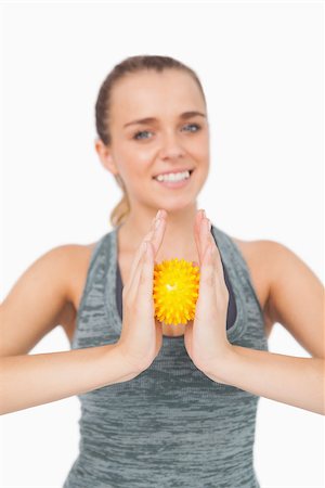 simsearch:400-07138263,k - Content woman holding a massage ball between her hands on white background Stock Photo - Budget Royalty-Free & Subscription, Code: 400-07138200